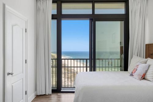 a bedroom with a bed and a view of the ocean at The Oasis at Orange Beach 1611 (Phoenix West II) in Orange Beach