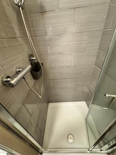 a shower with a glass door in a bathroom at Whitaker Lodge in Swinford