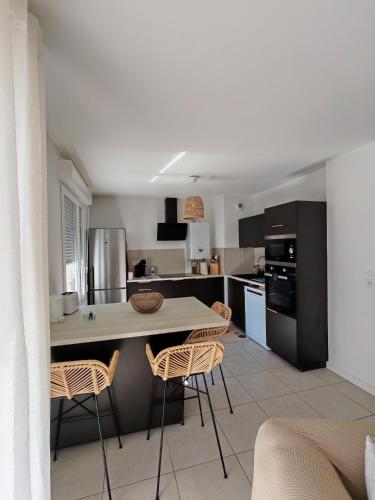 a kitchen with a table and chairs in a room at Cozy Home in Roussillon en Isere