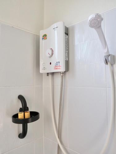 a shower in a bathroom with a hair dryer at W Smart Stay TRANG in Trang