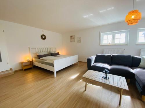 a living room with a couch and a bed at Ferienwohnung Am Steinberg in Nauendorf