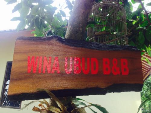 a sign that reads mimosaud bbb on a tree at Wina Ubud B&B in Ubud