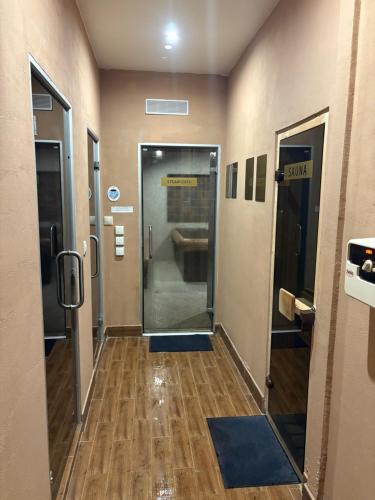 a hallway of a bathroom with a shower and a toilet at Chamkoria Forest apartment in Borovets