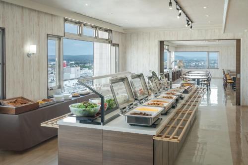 a buffet line with food on display in a restaurant at Premier Hotel -CABIN- Obihiro in Obihiro