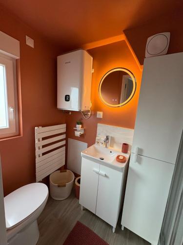 a small bathroom with a toilet and a sink at Studio cosy avec balcon in Dunkerque