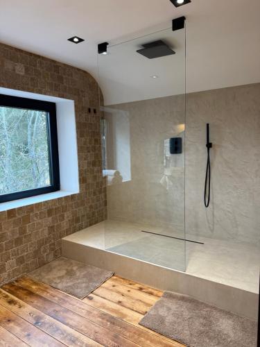 a bathroom with a shower with a glass enclosure at La fagnette in Jalhay