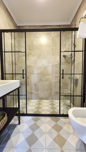 a bathroom with a glass shower and a sink at Feli Eski Datca Adult Only in Datca