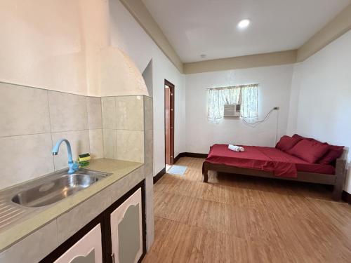 a kitchen with a red couch in a room at Boracay Garden Retreat in Boracay