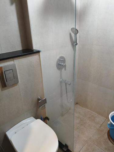 a shower stall with a toilet in a bathroom at 1 BHK apartment in Bangalore