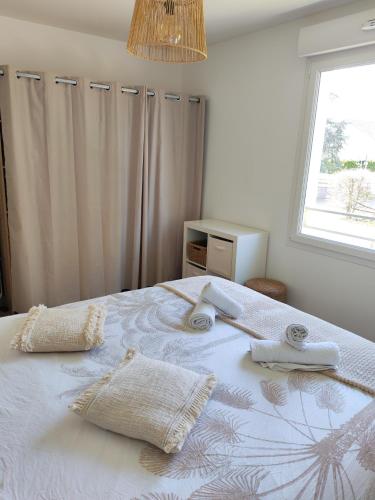a bedroom with a bed with towels on it at Cozy Home in Roussillon en Isere