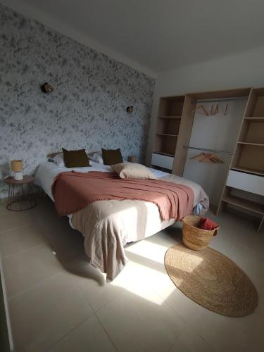 a bedroom with a large bed in a room at La maison Françine in Sénas