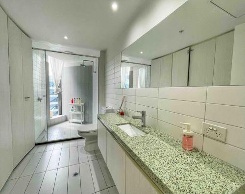 a bathroom with a sink and a toilet and a shower at Harbour Haven Sleep 7 Free Parking Free Tram to CBD in Melbourne