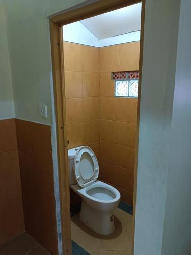 a bathroom with a toilet with the lid up at Glamping Camphills in Gunungpicung