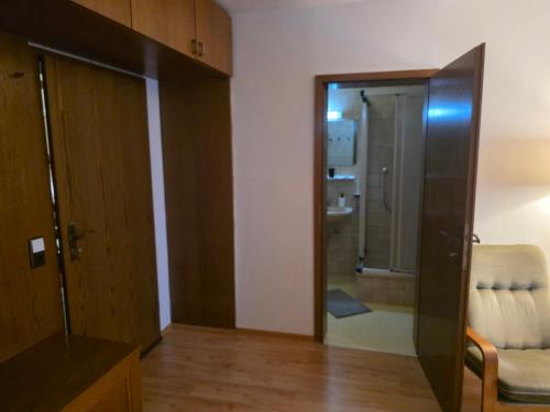 a bathroom with a glass door leading to a shower at Hotel Kaiser Friedrich in Bad Berleburg
