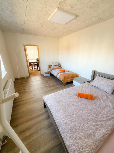a bedroom with two beds and a table in it at Mājīgs dzīvoklis Aizputē in Aizpute