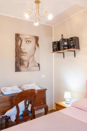 a bedroom with a bed and a desk with two cameras on the wall at La Casa dei Panorami in Castelsaraceno