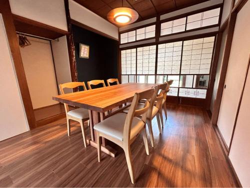 a dining room with a wooden table and chairs at tot-an 14mins from Toyama station #HH7 in Toyama Station