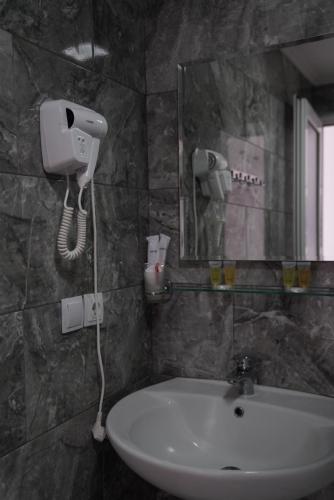 a bathroom with a sink and a mirror at Aventus Hotel in Akhaltsikhe