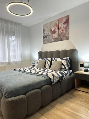 a bedroom with a large bed with pillows on it at Urban Studio 018 in Niš