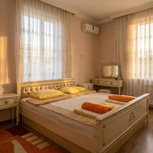 a large bed in a bedroom with a window at Sea View villa in Baku