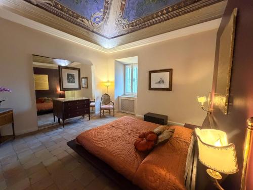 a bedroom with a large bed with a ceiling at L' Appartamento Experience in Tivoli