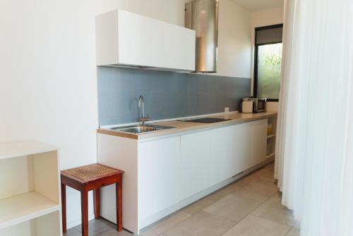 a kitchen with a sink and a counter top at Villa Alcova in Caorle