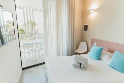 a bedroom with a bed with towels on it at Villa Alcova in Caorle