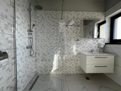 a white bathroom with a shower and a sink at Seranova Aparthotel 10 SELF CHECK-IN #Otopeni #Airport #Therme #Bucharest in Otopeni