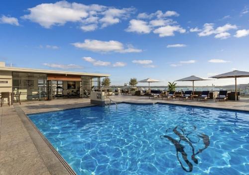 a swimming pool on the roof of a hotel at Sky Tower Serenity + Rooftop Pool in Auckland