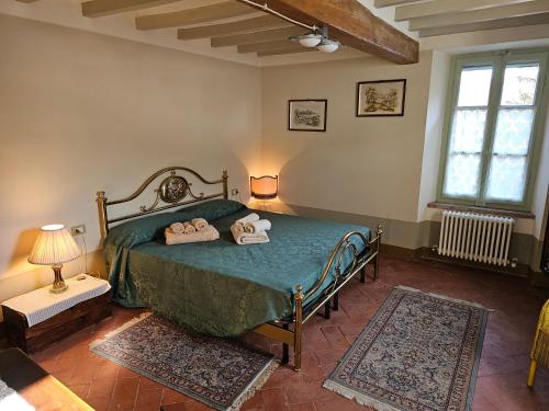 a bedroom with a bed with two towels on it at Sogni nel Bosco in Varsi