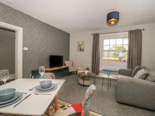 a living room with a couch and a table at Countryside Annexe, with hottub, sleeps up to 4 in Durston