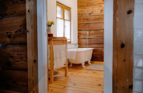 a bathroom with a bath tub and a window at Smykowe Doły in Wilczyce