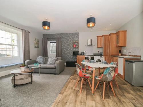 a kitchen and living room with a table and chairs at Countryside Annexe, with hottub, sleeps up to 4 in Durston