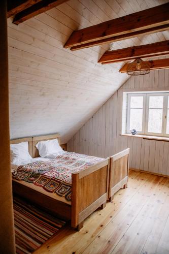 a bedroom with a large bed in a attic at Smykowe Doły in Wilczyce