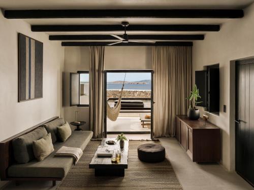 a living room with a couch and a table at ananea Mykonos - Adults Only in Ornos