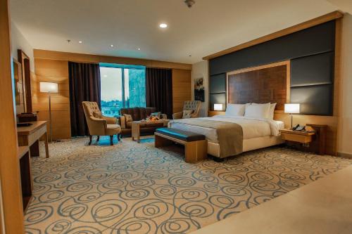 a hotel room with a bed and a desk at Coral Tower Hotel by Hansa in Amman