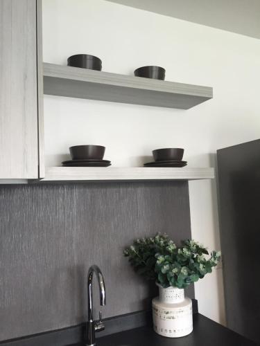 a kitchen sink with two bowls on a shelf at The 23 Estate by Away in Phayayen