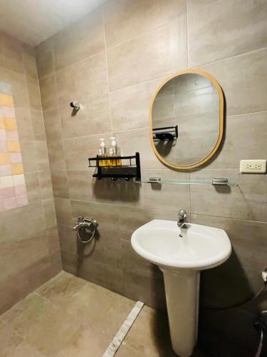 a bathroom with a sink and a mirror at Lanyu IGANG Hotel in Lanyu