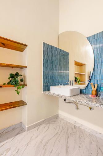 a bathroom with a sink and a mirror at Casa Century Anjuna in Anjuna