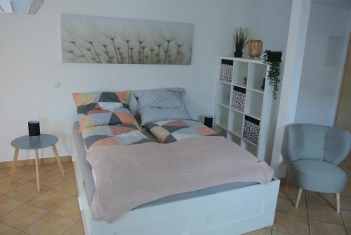 a living room with a bed and a chair at Ferienwohnung in Bad Schwalbach in Bad Schwalbach