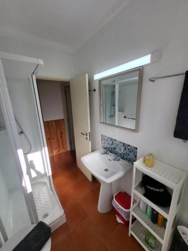 a bathroom with a sink and a mirror at casal do melro in Ericeira