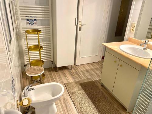 a bathroom with a white toilet and a sink at maison Basque Maïana in Anglet
