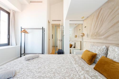 a bedroom with a large white bed and a window at Rossio individual Suites Lisbon in Lisbon