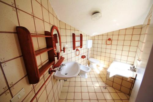a bathroom with a sink and a toilet at Villa Pentalocale cod 168- Taunus Vacanze in Numana