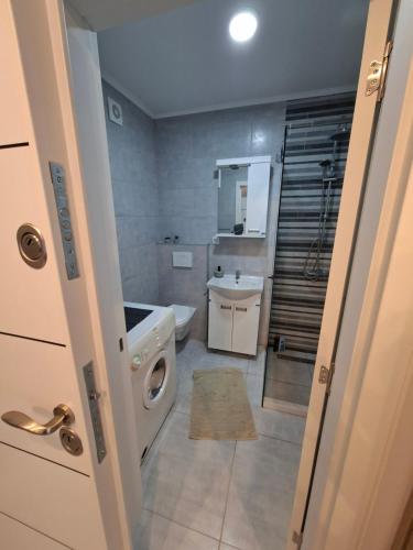 a bathroom with a sink and a washing machine at Silver 2 & SPA in Veliko Gradište
