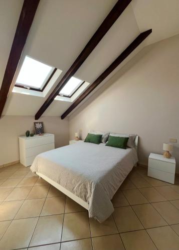 a bedroom with a large bed with two skylights at Mokka Loft in Biella