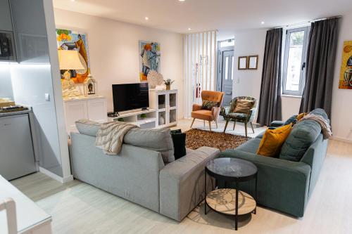 a living room with two couches and a tv at OPORTO GUEST - Maia House in Porto