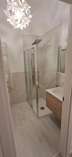 a bathroom with a shower and a sink and a chandelier at Trivia Rent in Reggio di Calabria