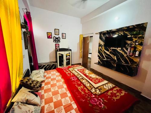 a bedroom with a bed with a red blanket at Rr Complex in Nalmatha