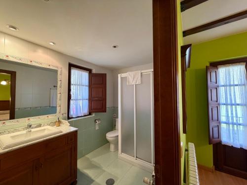 a bathroom with a sink and a toilet at Casas Rurales Las Corradas in Éndriga